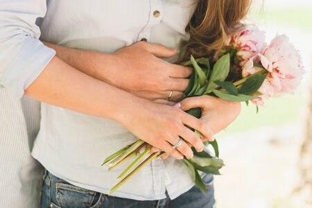 engaged couple hug together. Close up shot of handsの写真素材
