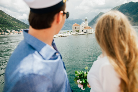 honeymoon couple travel Europe on yacht. Back view. Montenegro, Perastの写真素材
