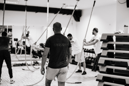 crossfit group training. Man and woman group training indoors. Black and white