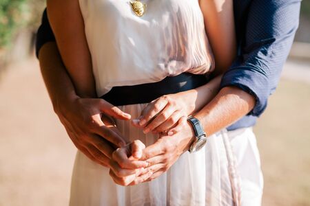 engaged couple hug together. Close up shot of handsの写真素材