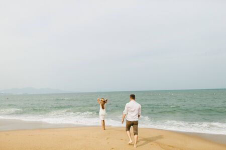 couple relax on beach together. Sea view and sandy beach in Asia, Vietnamの写真素材