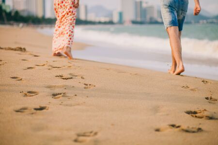 couple walk on beach together. Steps and sandy beach viewの写真素材