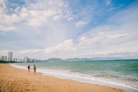 couple relax on beach together. Sea view and sandy beach in Asia, Vietnamの写真素材