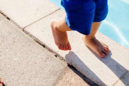 child walk feet close up. Blue shortsの写真素材