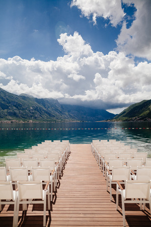 wedding chairs with flowers decoration. Wedding venue ceremony.の写真素材