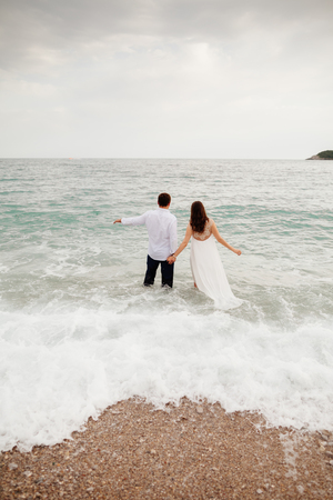 couple relax on beach together. Sea view and sandy beach.の写真素材