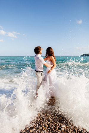 couple relax on beach together. Sea view and sandy beach.の写真素材