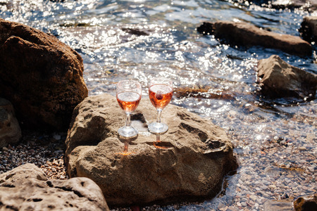 Strawberry Champagne cocktail. rocky beach and sea viewの写真素材
