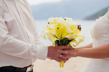 bride and groom holding hands together. Fine art styleの写真素材