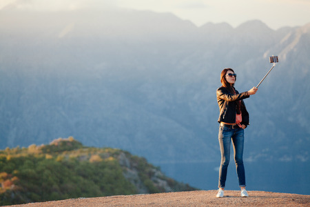 joyful woman travel and photo selfie in mountains. Picturesque location in Montenegro, Europe.の写真素材