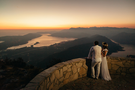 honeymoon couple travel mountains and sea view. Sunset in picturesque mountains. Kotor Bay, Montenegro.の写真素材