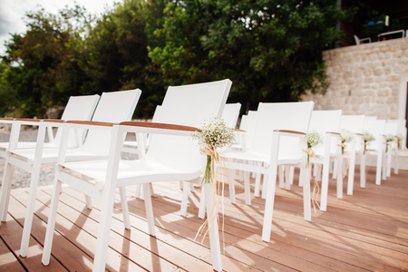 wedding chairs with flowers decoration. Wedding venue ceremony.の写真素材