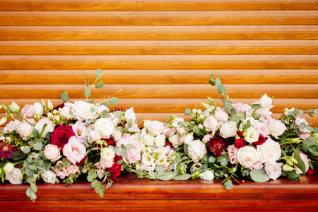 wedding flowers decoration on wood background. Red and pink rosesの写真素材