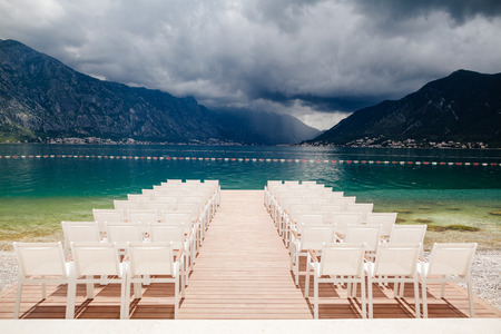 wedding chairs with flowers decoration. Wedding venue ceremony.の写真素材