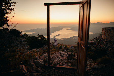honeymoon couple travel mountains and sea view. Sunset in picturesque mountains. Kotor Bay, Montenegro.の写真素材