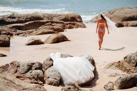 bride travel beach resort in bikini swimsuit. Honeymoon with sea view and beach in tropicsの写真素材