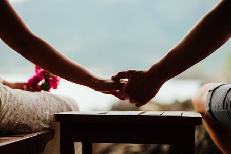 lovely couple holding hands together. Close up shotの写真素材