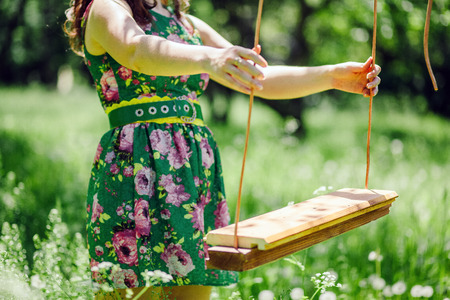 couple sitting on swing in park. Green garden.の写真素材