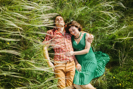 couple relax in grass. Top view. Green meadow in summer. Countryside.の写真素材