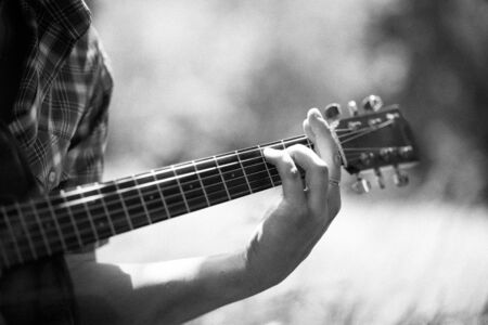 man playing guitar on picnic. Monochrome.の写真素材