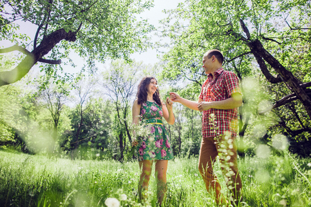 couple relax in green garden. Lovely couple walk in green meadow.の写真素材