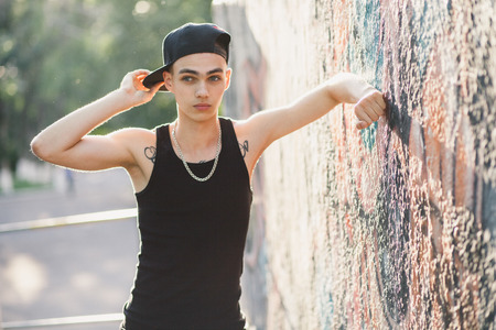 hip hop teenage man. Teenager relax on street in cap.の写真素材
