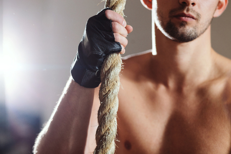 rope climbing workout athlete man in gymの写真素材