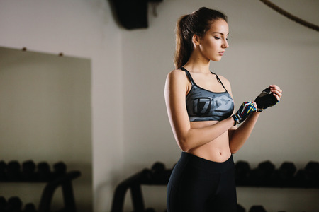 fitness teenage woman in gym warming up. Slim fitness model in gym.の写真素材