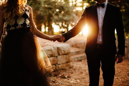 couple holding hands silhouette. Fancy couple at sunset.
