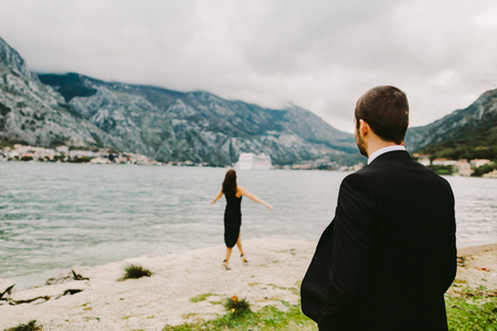 couple travel mountains and sea view. Picturesque landscape. Travelling Europe at honeymoon. Mountains and sea view at sunset.の写真素材