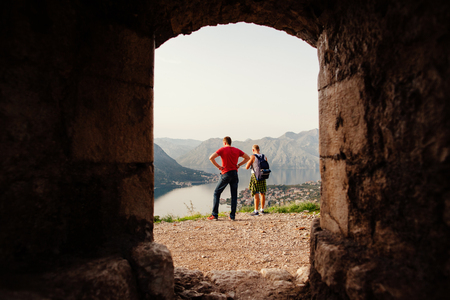 backpacker men travel mountains and bay view. Kotor Bay, Montenegro. Shot through the wall.の写真素材