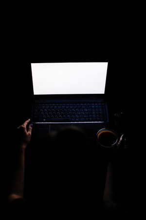 Young Girl With Laptop At Night. Laptop mockup.の写真素材