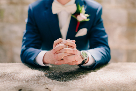 groom hands with ring and watches. man in suitの写真素材