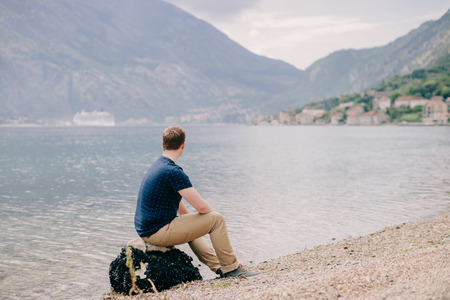 man travel rocky beach and mountains bay view. Kotor Bay, Montenegroの写真素材