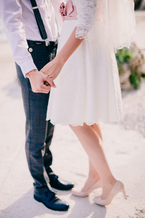 bride and groom holding hands together. Fine art styleの写真素材