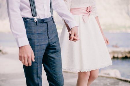 bride and groom holding hands together. Fine art styleの写真素材