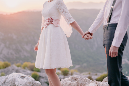 honeymoon wedding couple travel back view. Sunset in mountainsの写真素材