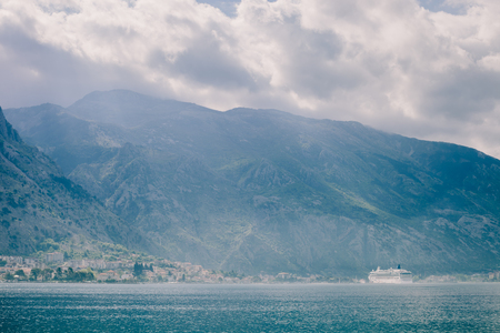 cruise ship sailing in beautiful bay with mountains. Kotor Bay, Montenegro.の写真素材