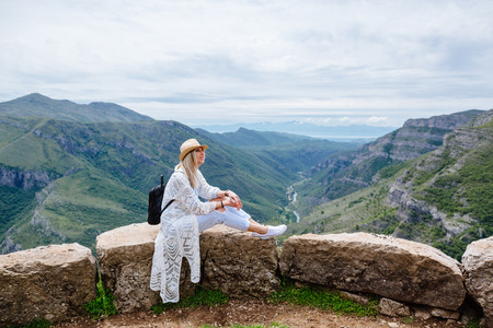 joyful woman travel mountains with backpack. Authentic blonde female relax in picturesque landscape. Montenegro, Prokletijeの写真素材