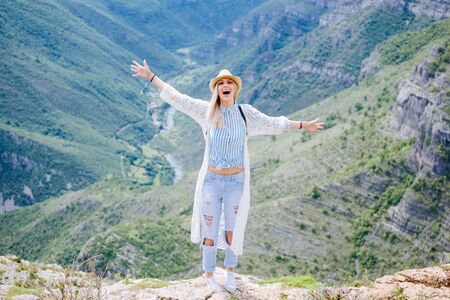 joyful woman travel mountains. Blonde female relax in picturesque landscape. Montenegro, Prokletijeの写真素材
