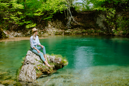 woman relax at mountain lake view. Auhentic Blonde woman travel in Montenegro, Skakavice Oko.の写真素材