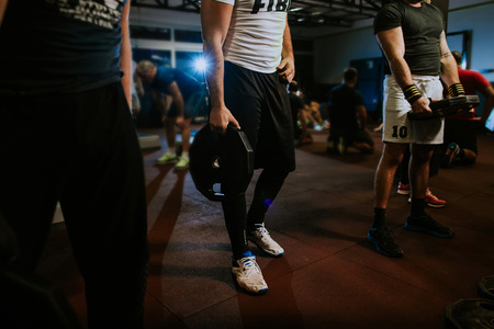 Cross fitness group training workout indoors. Group fitness workout with weightsの写真素材