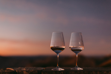wine glasses at sunset. Beautiful view. White wineの写真素材