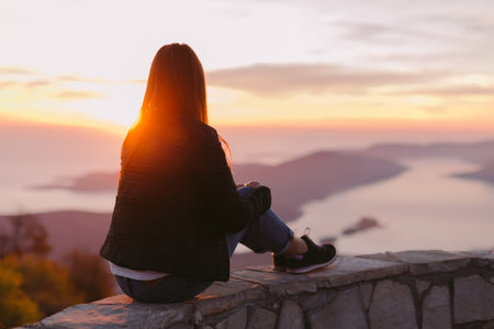 woman relax in mountains at sunset with beautiful view. Picturesque landscape background.の写真素材