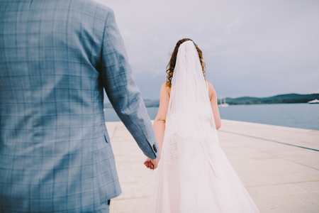 wedding couple relax on beach in summer. Sea view with mountainsの写真素材