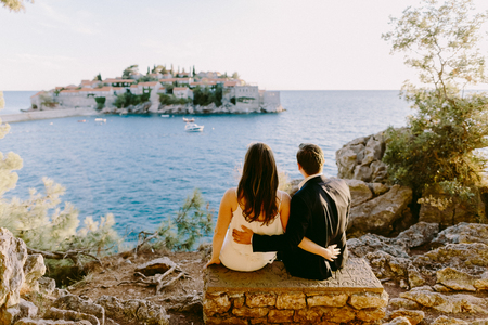 couple travel sea side with island view in Montenegroの写真素材