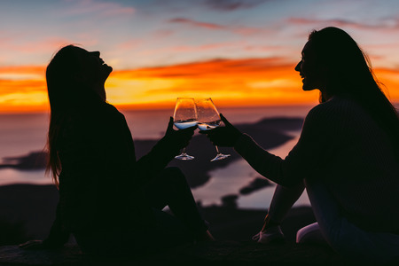women drink wine together at sunset in mountains. Beautiful view,. Montenegro, Kotorの写真素材