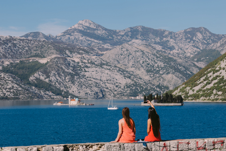 two girls travelling sea and mountains view in Montenegro. Perast.の写真素材