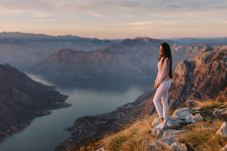 woman relax in mountains at sunset with beautiful view. Picturesque landscape background.の写真素材