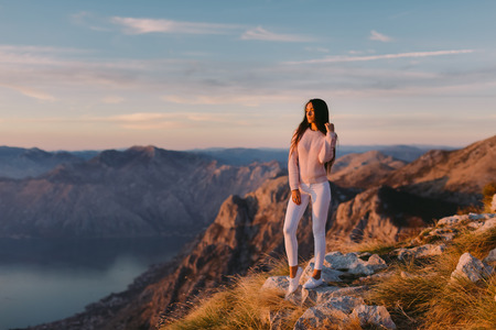 woman relax in mountains at sunset with beautiful view. Picturesque landscape background.の写真素材